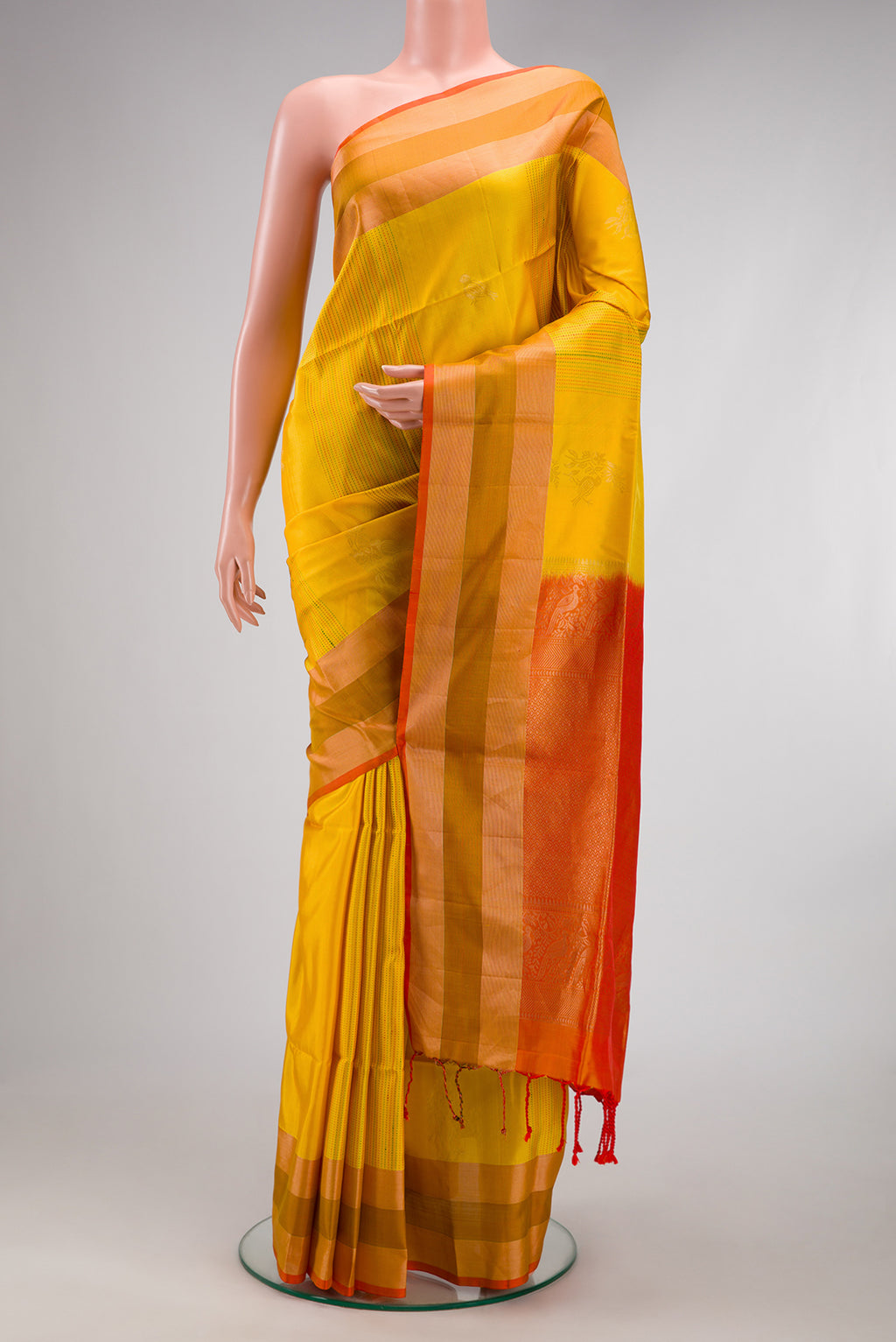 Yellow Soft Silk Saree with Stripes on the body and Zari Border.  displayed on a mannequin