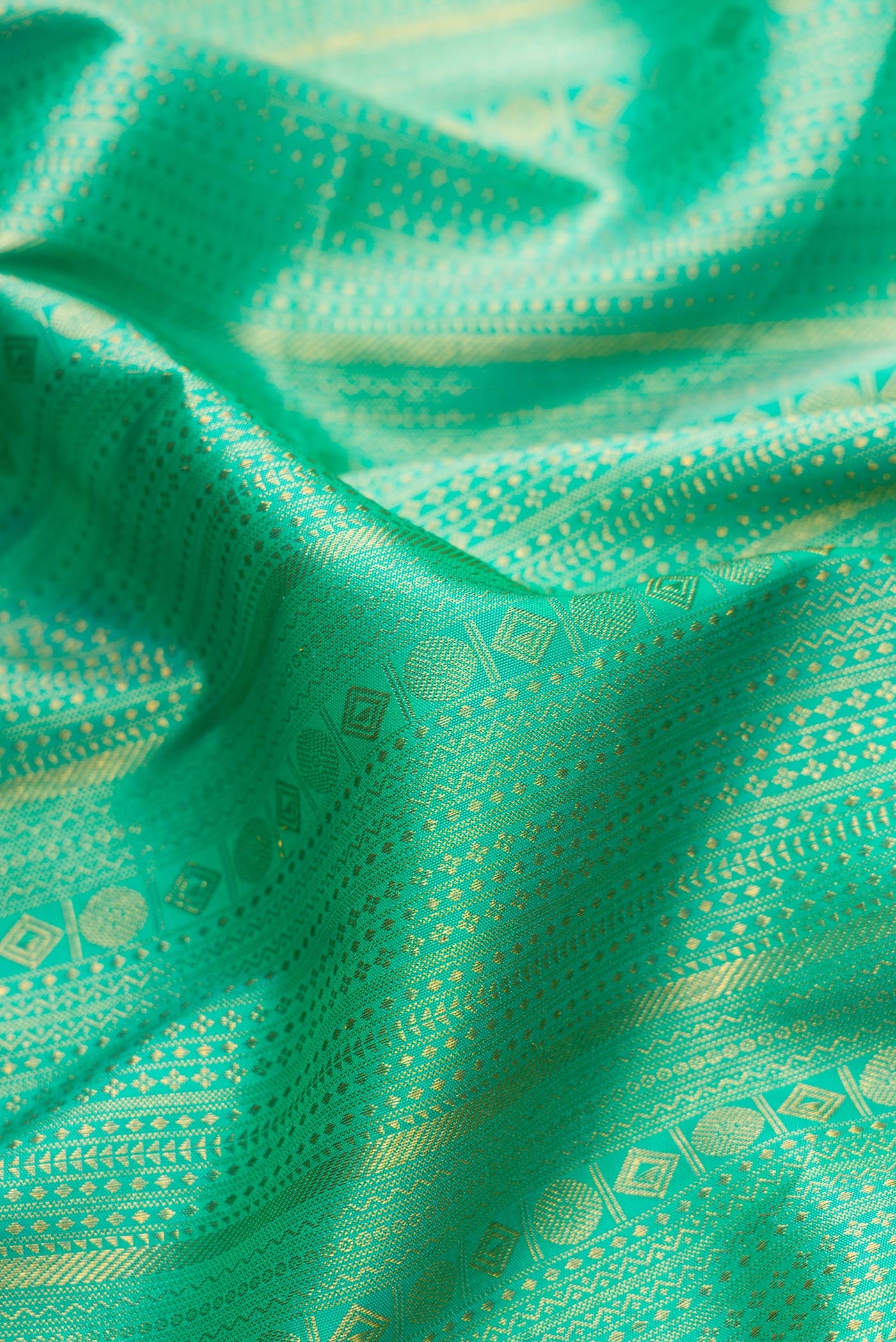 Close up of Sea Green Dual Tone Kanjivaram Silk Saree with Zari Brocade on the body and Zari Border.  displaying folds
