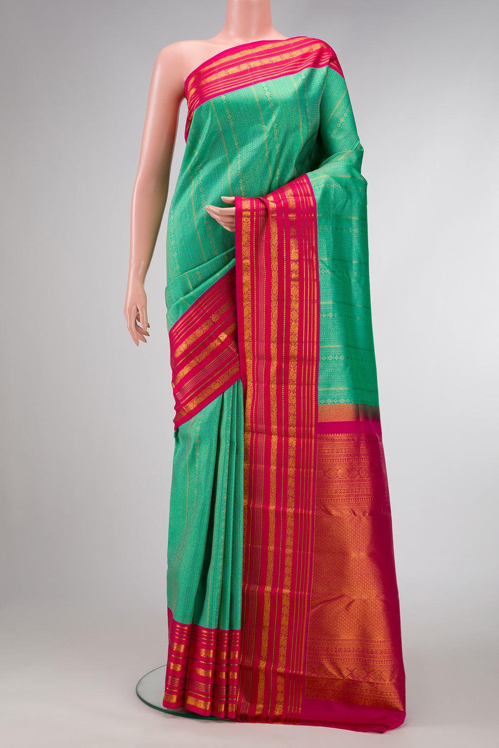 Sea Green Dual Tone Kanjivaram Silk Saree with Zari Brocade on the body and Zari Border.  displayed on a mannequin