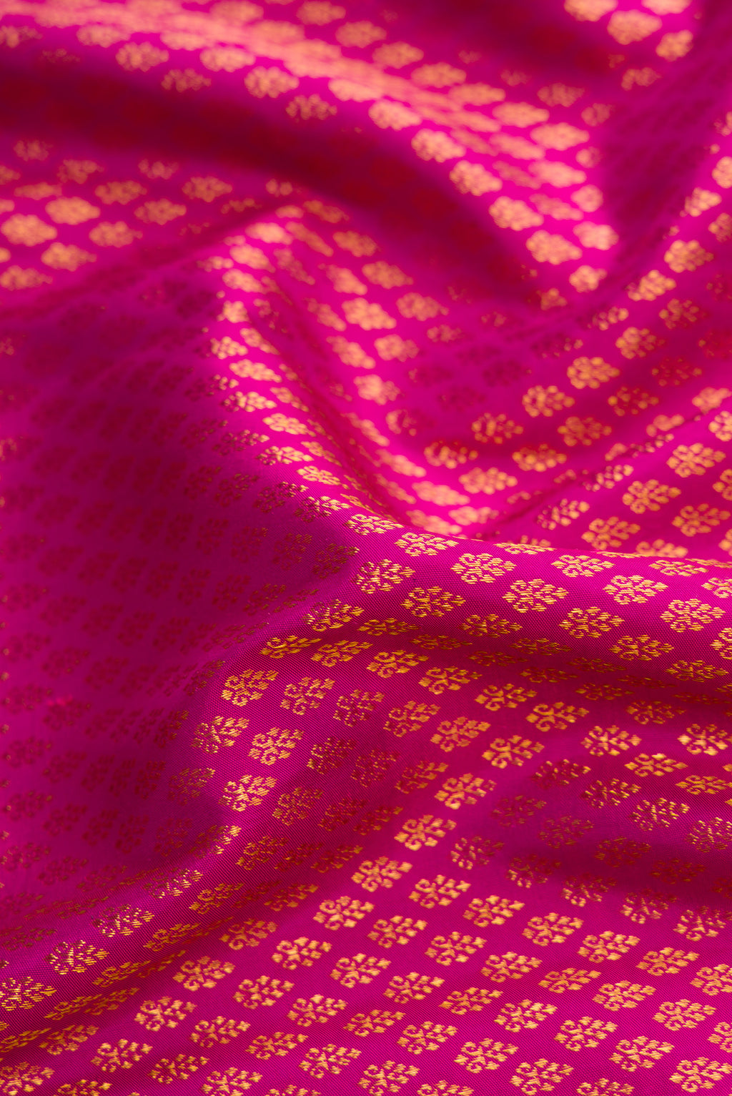 Close up of Magenta Dual Tone Kanjivaram Silk Saree with Zari Brocade on the body and Zari Border.  displaying folds