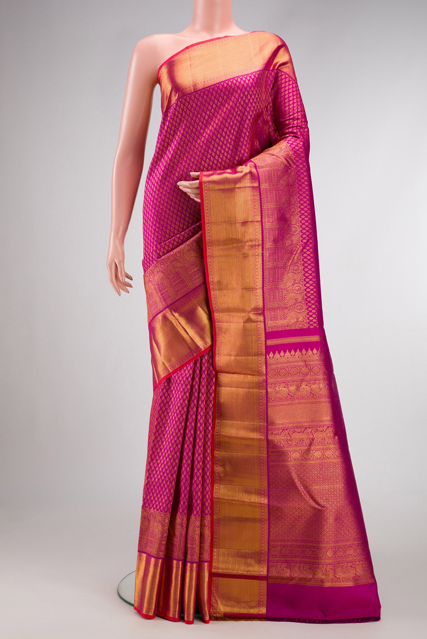Magenta Dual Tone Kanjivaram Silk Saree with Zari Brocade on the body and Zari Border.  displayed on a mannequin