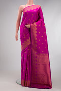 Magenta Kanchipuram Silk Saree with Zari Butta on the body and Fancy Border.  displayed on a mannequin