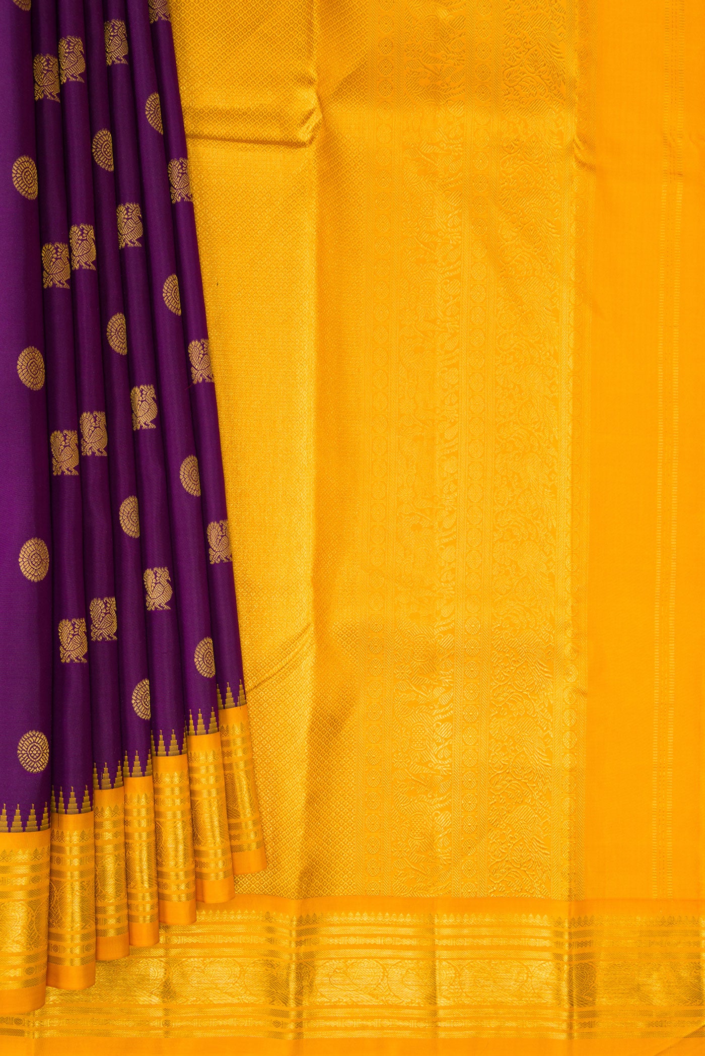 Pleats and pallu of Purple Kanchipuram Silk Saree with Zari Butta on the body and Zari Border. 