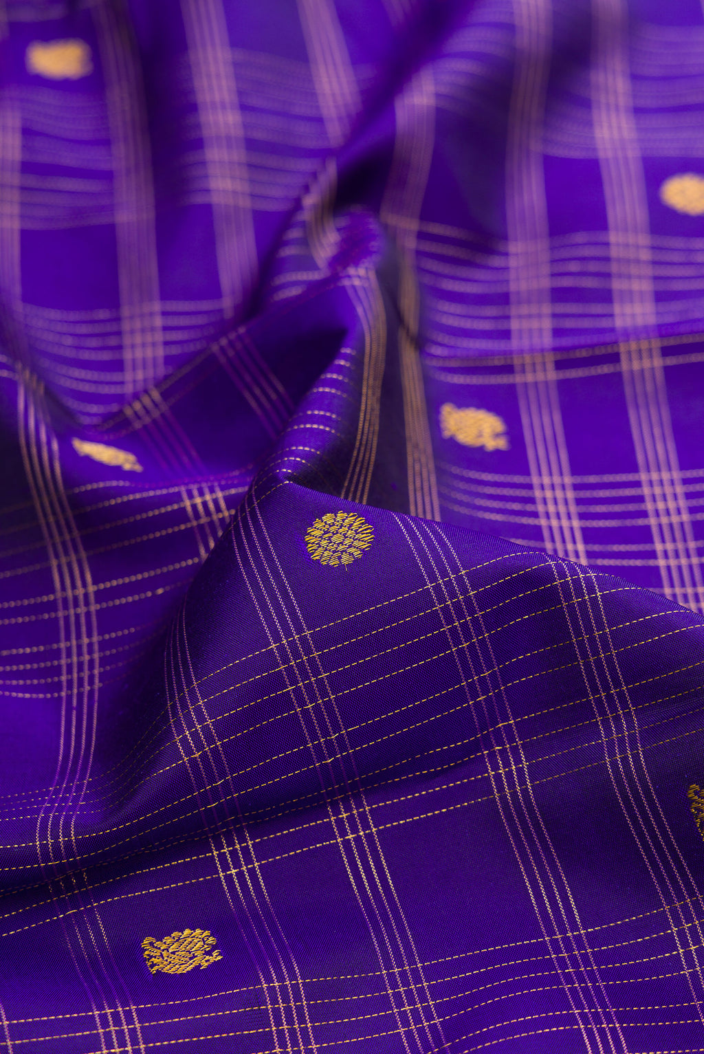 Close up of Dark Blue Kanchipuram Silk Saree with Checked design on the body and Without Border.  displaying folds