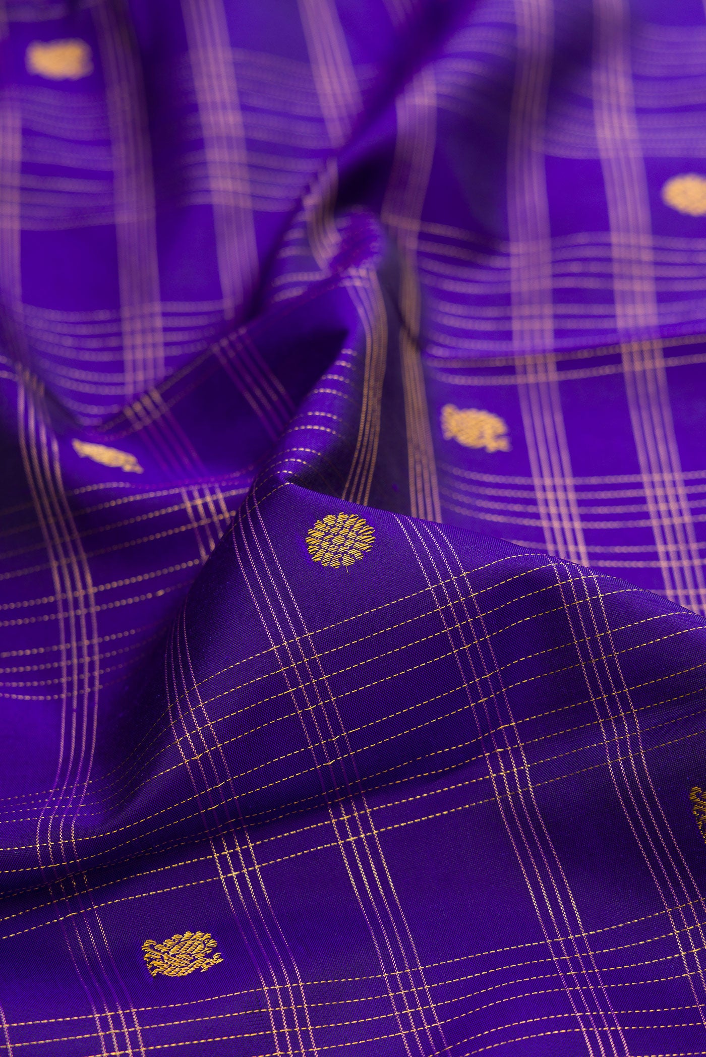 Close up of Dark Blue Kanchipuram Silk Saree with Checked design on the body and Without Border.  displaying folds