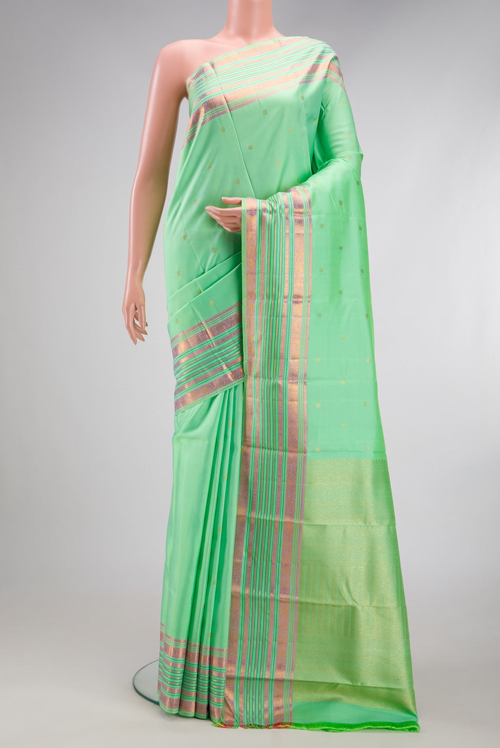 Pista Green Kanchipuram Silk Saree with Zari Butta on the body and Fancy Border.  displayed on a mannequin