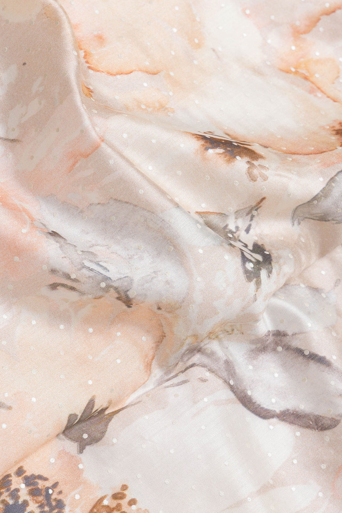 Close up of Rose Gold Dual Tone Tussar Silk Saree with Printed design on the body and Zari Border.  displaying folds