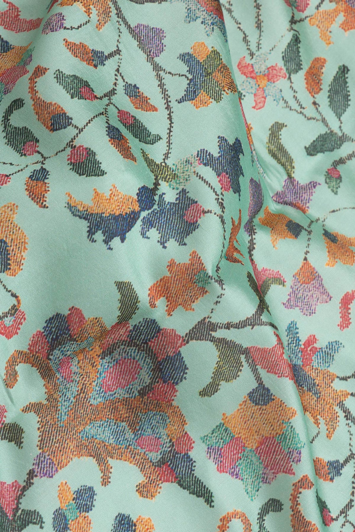 Close up of Sea Green Dual Tone Chanderi Silk Saree with Printed design on the body and Zari Border.  displaying folds