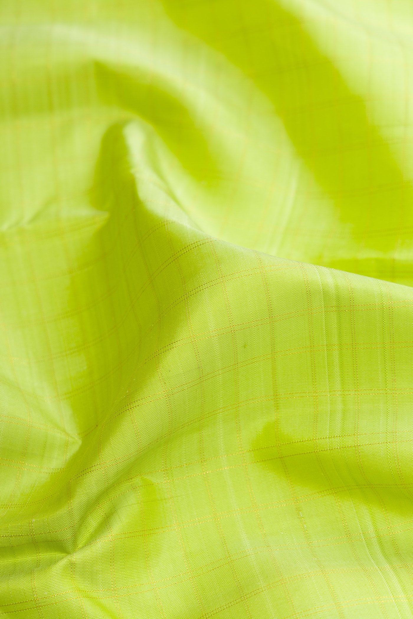 Close up of Parrot Green Dual Tone Kanchipuram Silk Saree with Plain Body and Fancy Border.  displaying folds