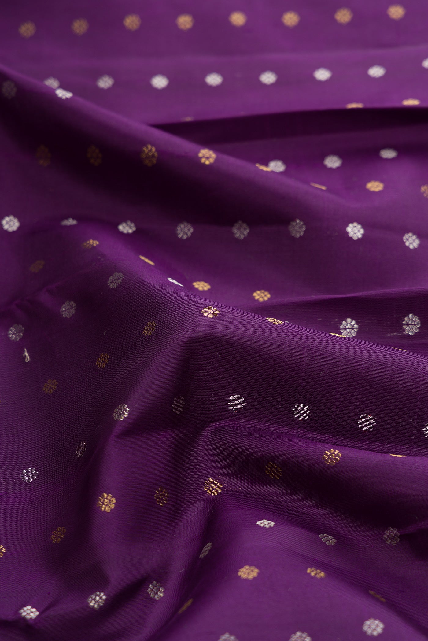 Close up of Pure Silk Pure Zari Navy Blue Dual Tone Kanjivaram Saree with Zari Butta on the body and Fancy Border.  displaying folds
