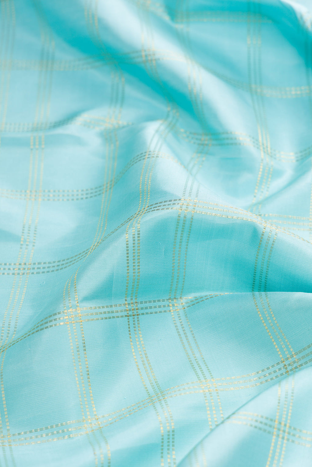 Close up of Sky Blue Dual Tone Kanjivaram Tissue Silk Saree with Checked design on the body and Fancy Border.  displaying folds