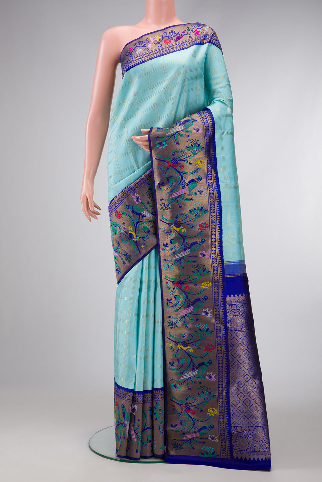 Sky Blue Dual Tone Kanjivaram Tissue Silk Saree with Checked design on the body and Fancy Border.  displayed on a mannequin