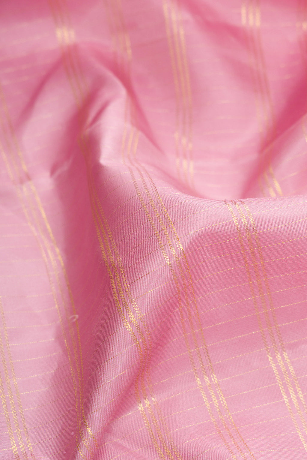 Close up of Pink Dual Tone Kanchipuram Silk Saree with Checked design on the body and Fancy Border.  displaying folds