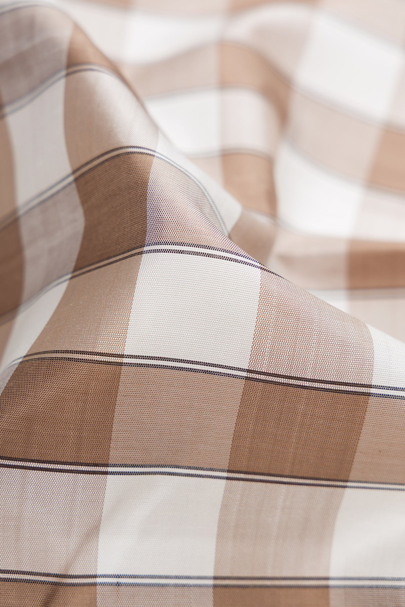 Close up of Pure Silk Pure Zari Beige and Off White Color Kanchipuram Saree with Checked design on the body and Zari Border.  displaying folds