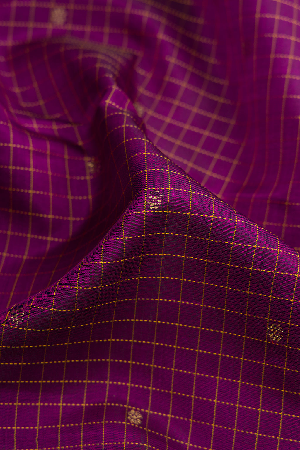 Close up of Pure Silk Pure Zari Burgundy Dual Tone Kanchipuram Saree with Checked design on the body and Fancy Border.  displaying folds