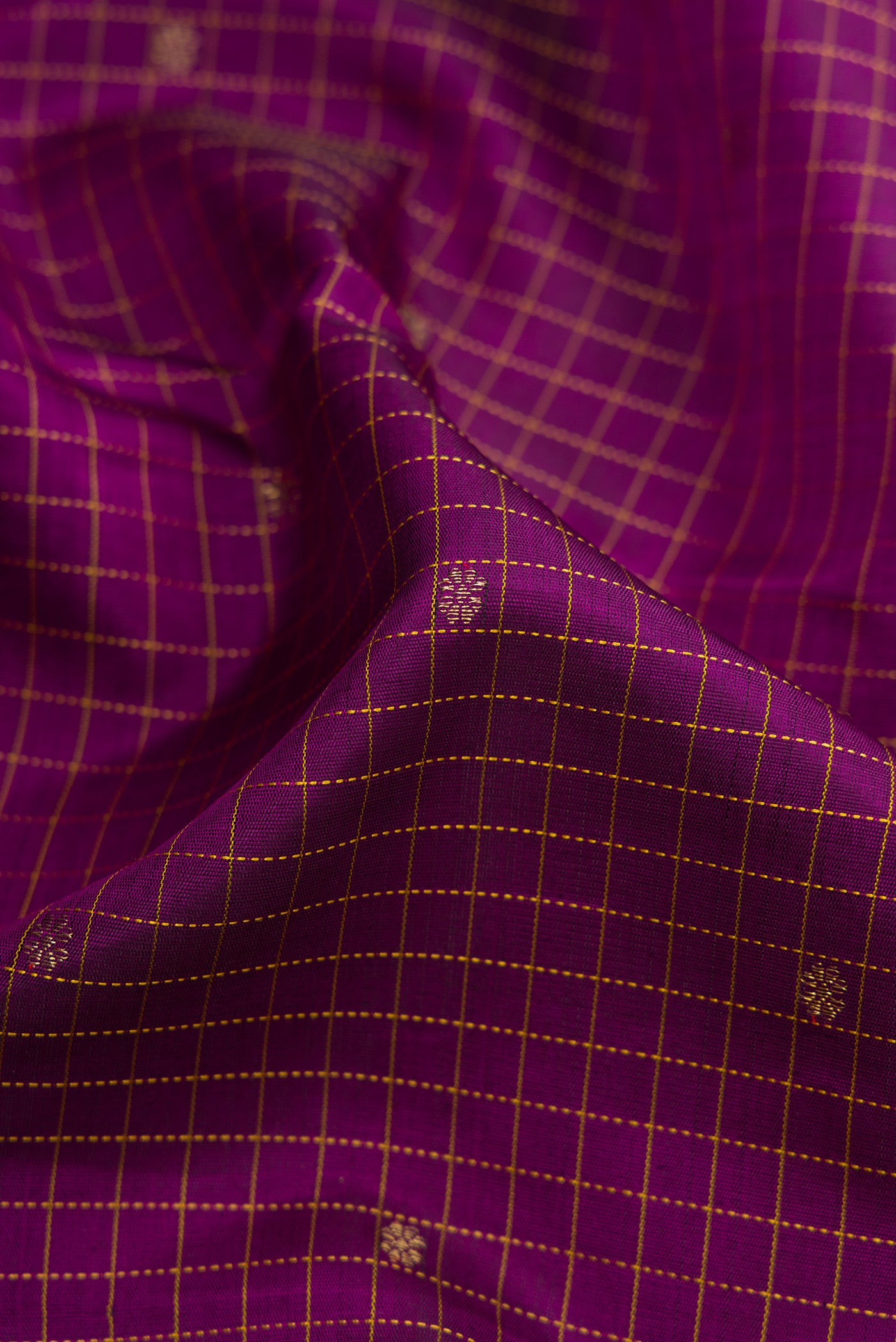 Close up of Pure Silk Pure Zari Burgundy Dual Tone Kanchipuram Saree with Checked design on the body and Fancy Border.  displaying folds