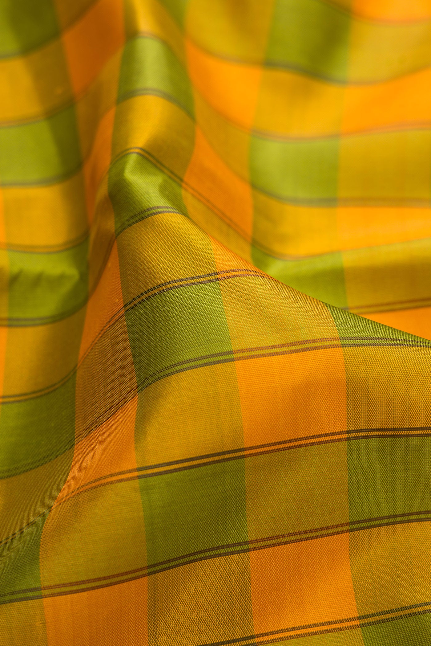 Close up of Pure Silk Pure Zari Green and Yellow Color Kanchipuram Saree with Checked design on the body and Temple Border.  displaying folds