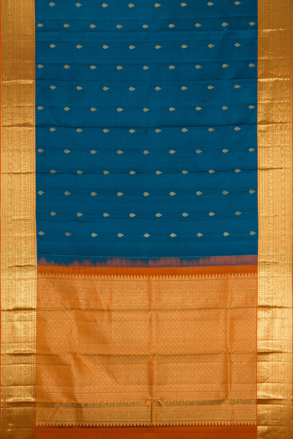 Flat view of Peacock Blue Kanchipuram Silk Saree with Zari Butta on the body and Zari Border. 