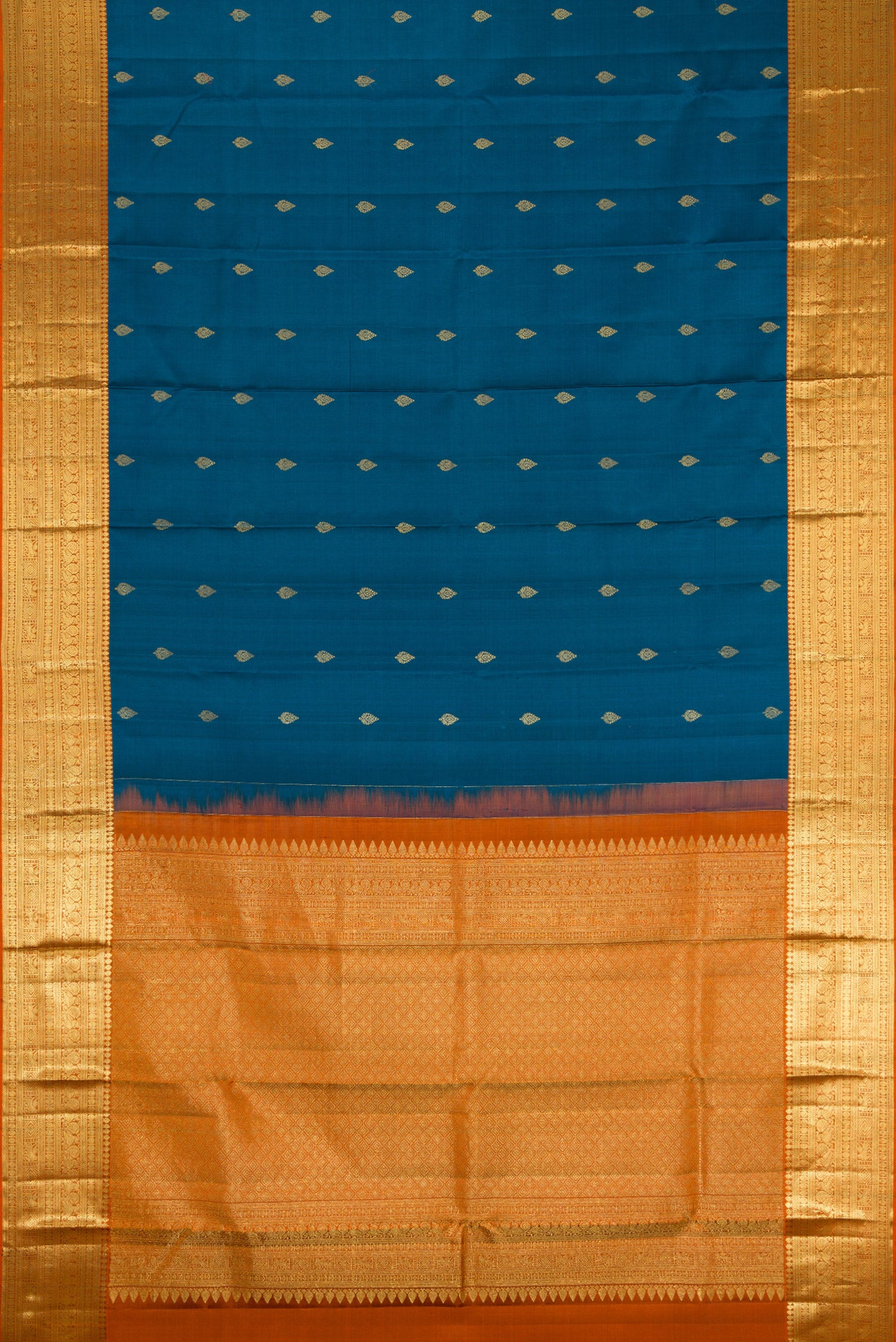 Flat view of Peacock Blue Kanchipuram Silk Saree with Zari Butta on the body and Zari Border. 