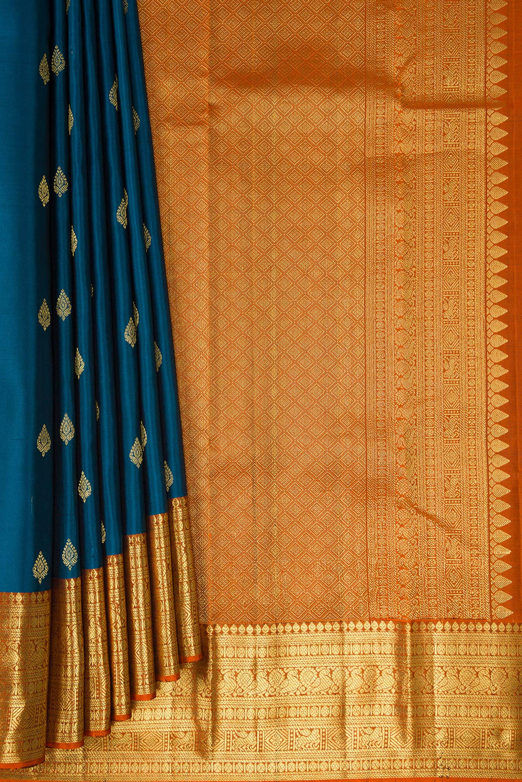 Pleats and pallu of Peacock Blue Kanchipuram Silk Saree with Zari Butta on the body and Zari Border. 