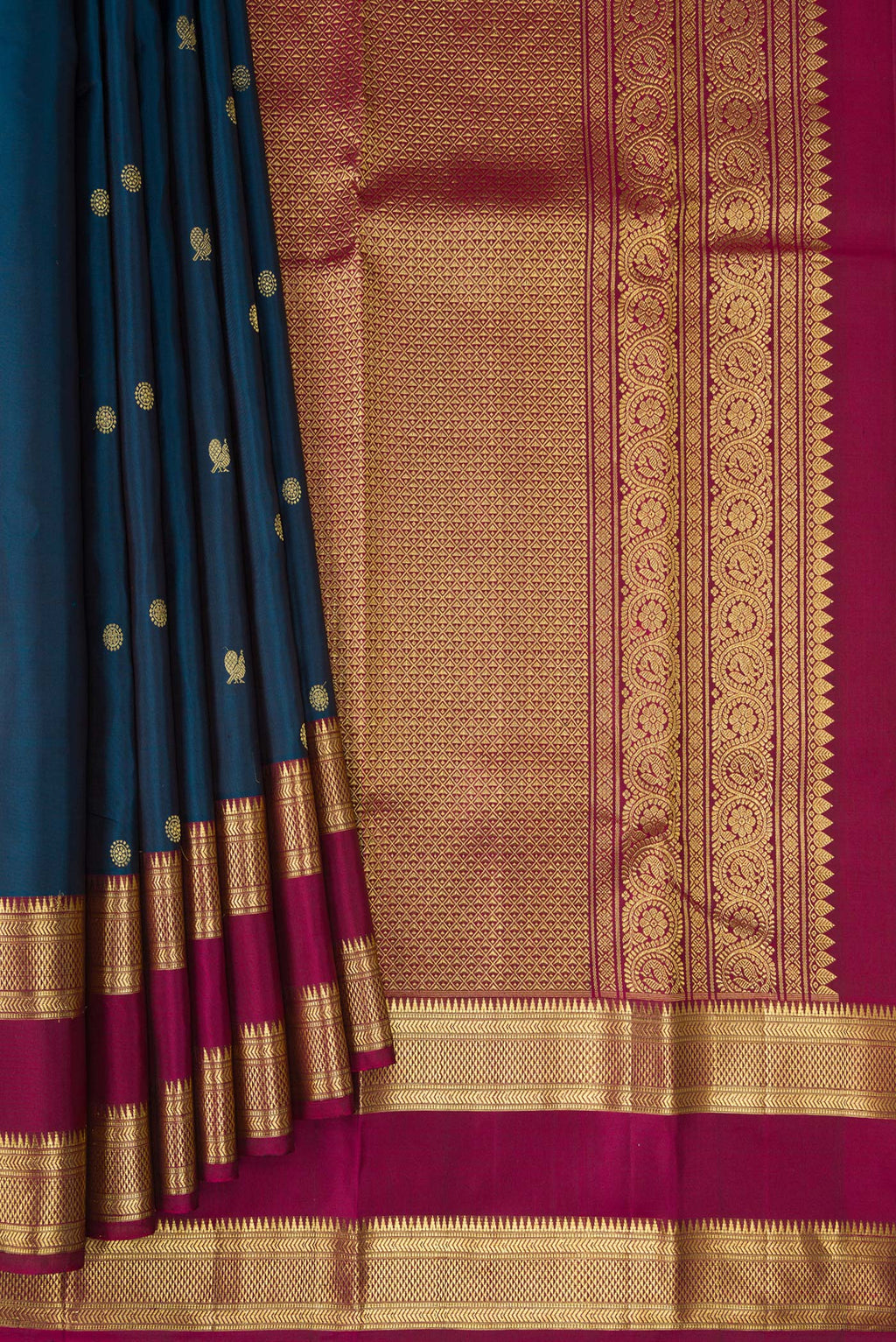 Pleats and pallu of Peacock Blue Kanchipuram Silk Saree with Zari Butta on the body and Zari Border. 