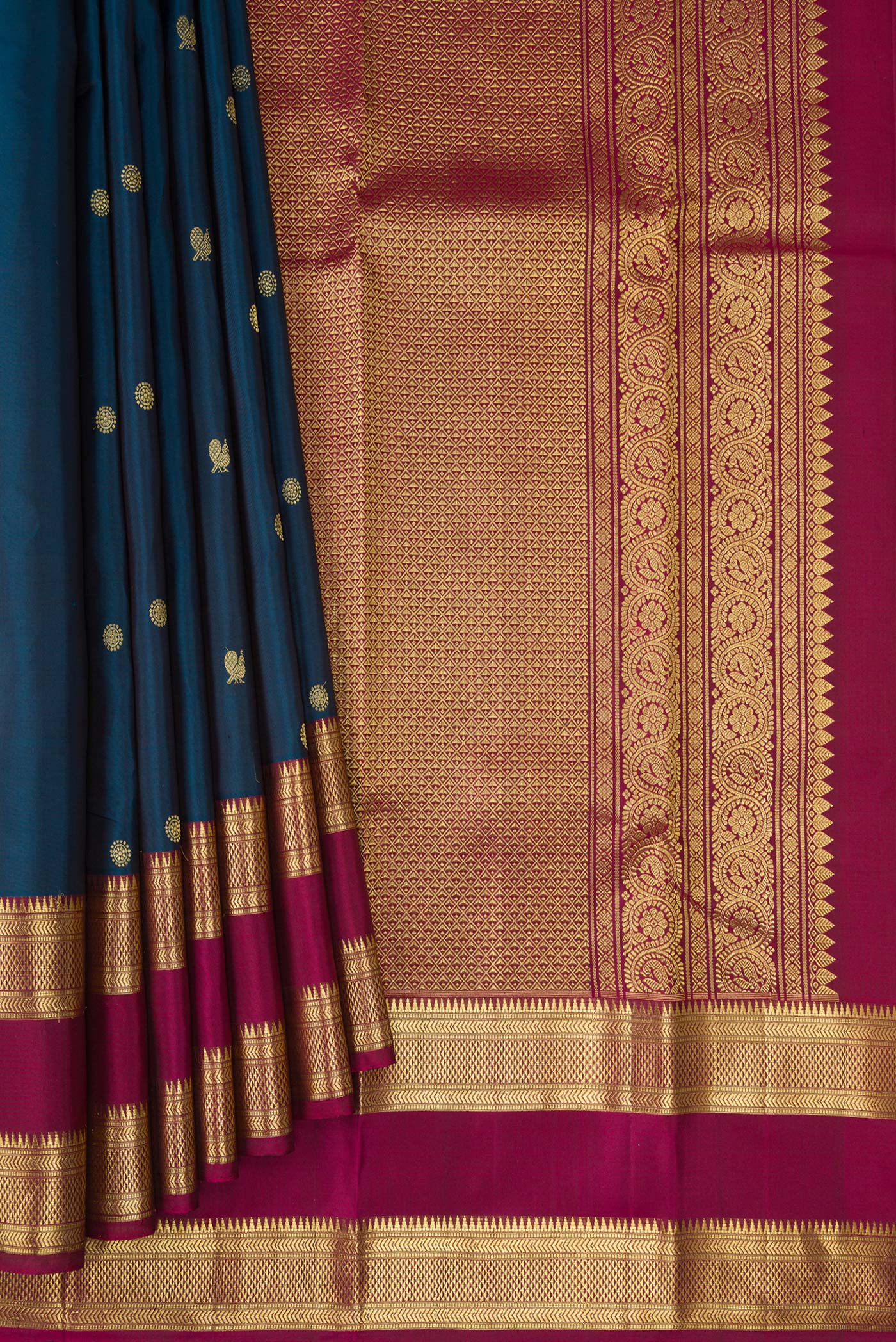Pleats and pallu of Peacock Blue Kanchipuram Silk Saree with Zari Butta on the body and Zari Border. 