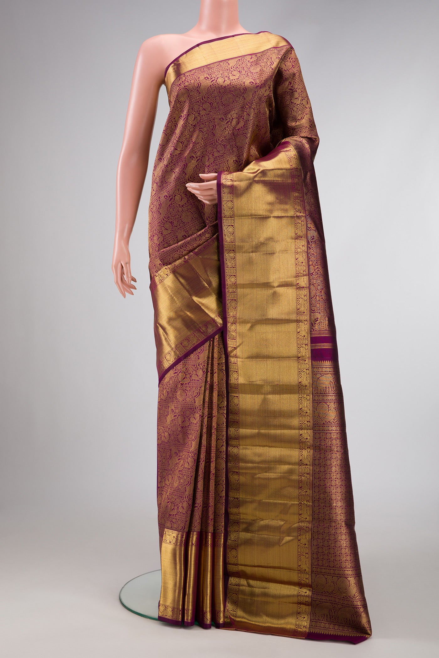 Pure Silk Pure Zari Burgundy Dual Tone Kanjivaram Saree with Zari Brocade on the body and Zari Border.  displayed on a mannequin