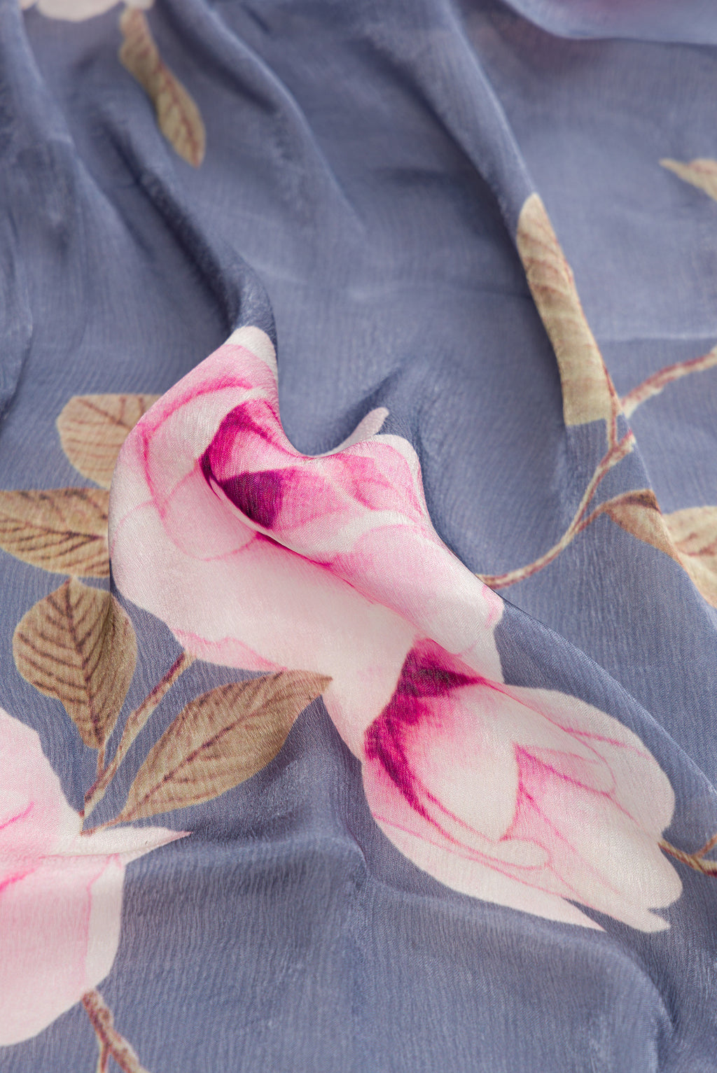 Close up of Grey Dual Tone Organza Silk Saree with Printed design on the body and Embroidery Border.  displaying folds