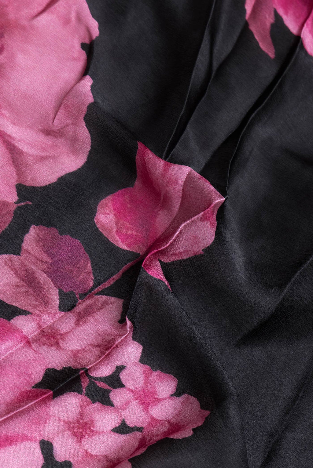 Close up of Black Dual Tone Mysore Crepe Saree with Printed design on the body and Embroidery Border.  displaying folds