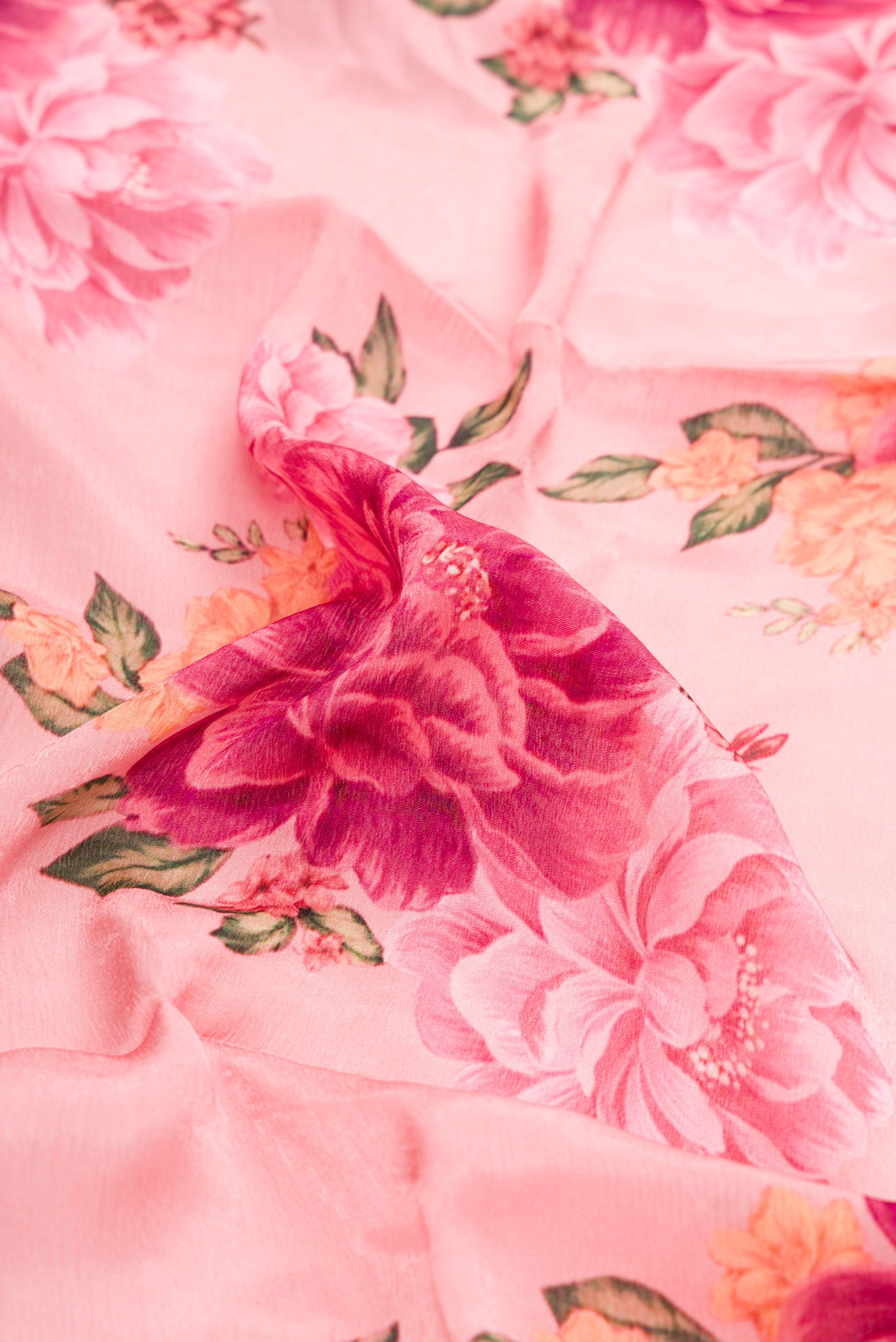 Close up of Pink Dual Tone Organza Silk Saree with Printed design on the body and Embroidery Border.  displaying folds