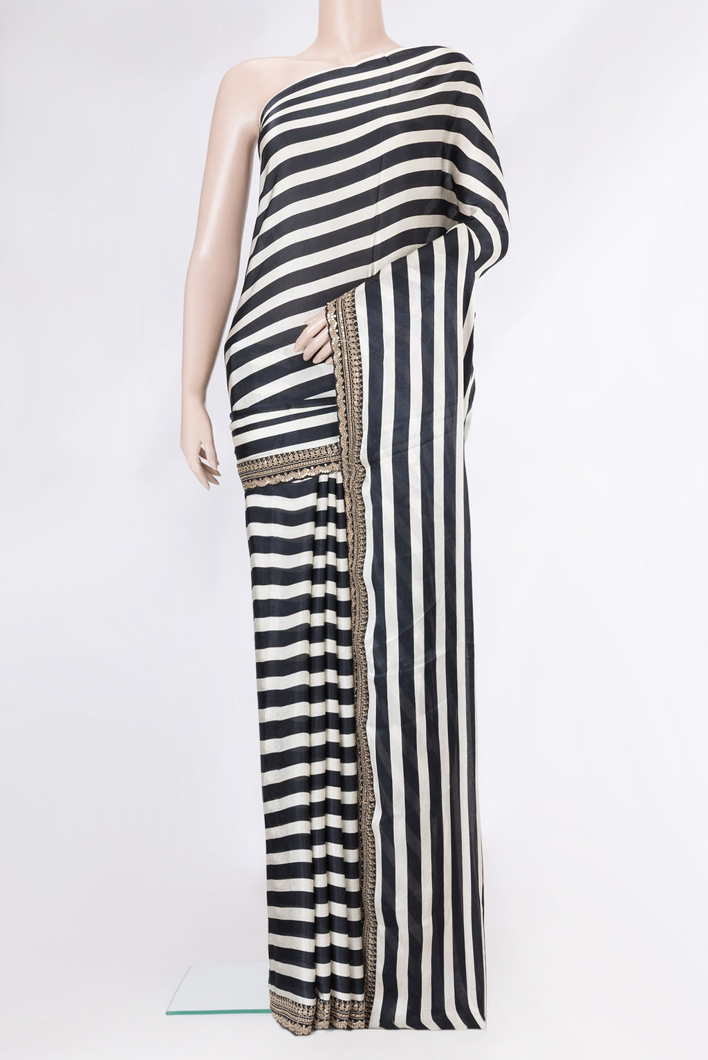 Black and Off White Color Crepe Saree with Stripes on the body and Embroidery Border.  displayed on a mannequin