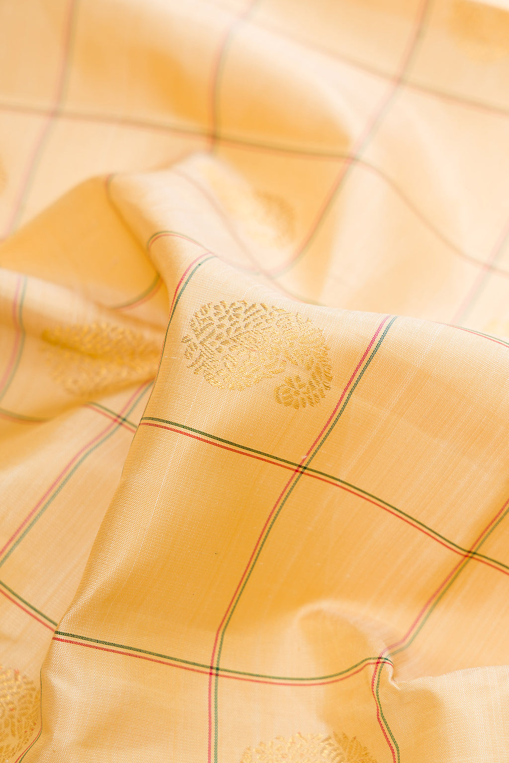 Close up of Pure Silk Pure Zari Sandal Dual Tone Kanchipuram Saree with Checked design on the body and Ganga Jamuna Border.  displaying folds