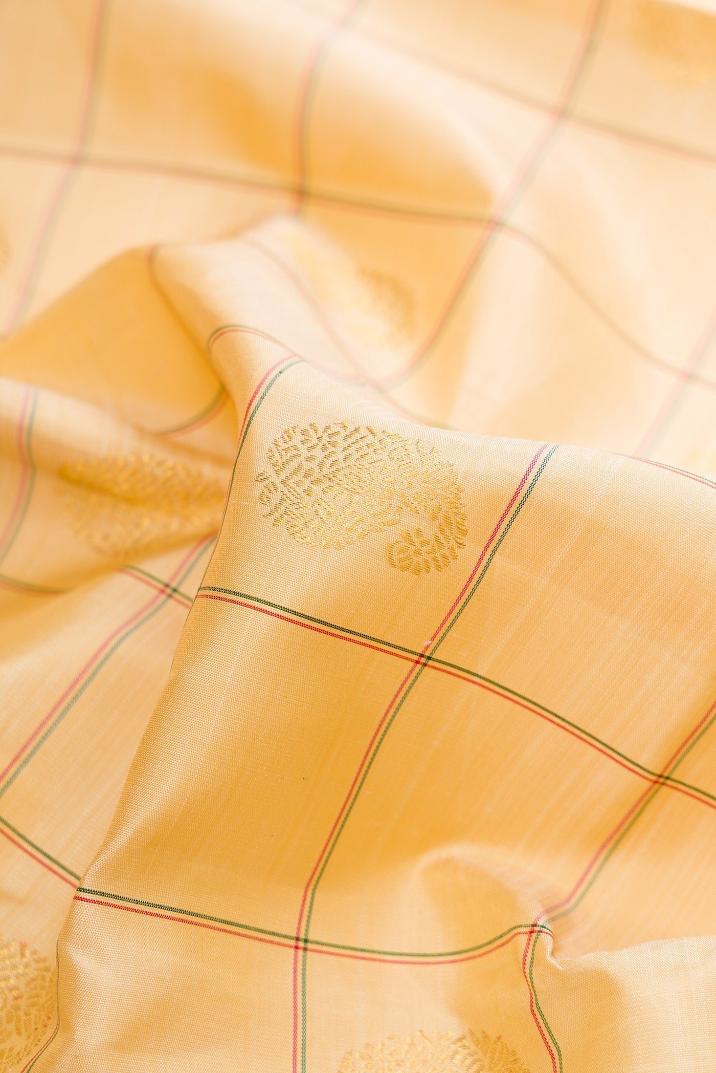 Close up of Pure Silk Pure Zari Sandal Dual Tone Kanchipuram Saree with Checked design on the body and Ganga Jamuna Border.  displaying folds