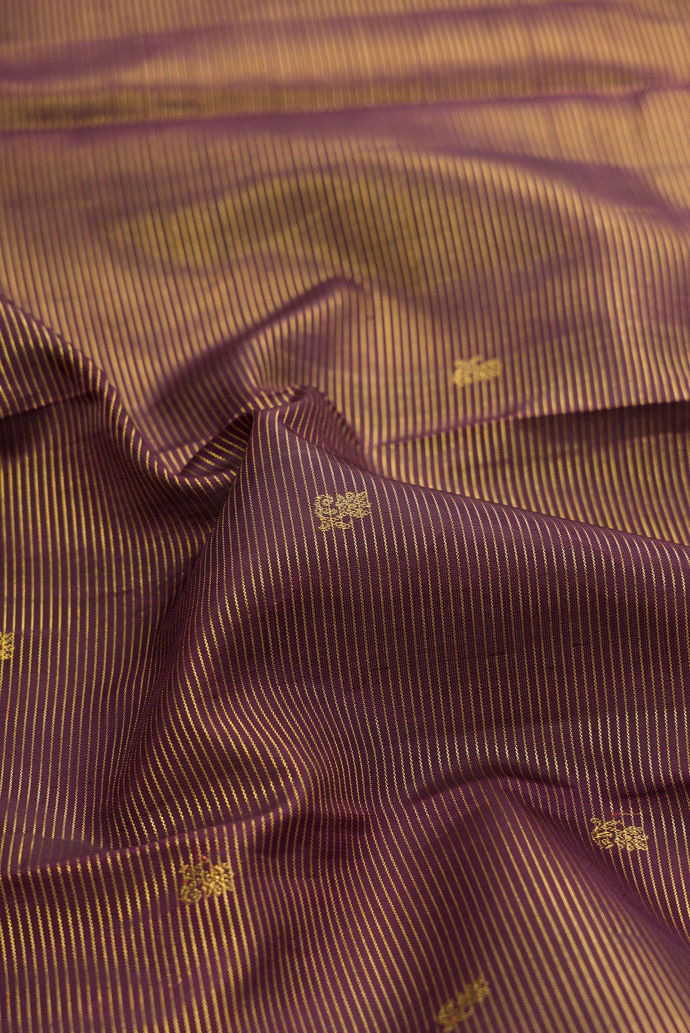 Close up of Coffee Brown Kanchipuram Silk Saree with Zari Butta on the body and Zari Border.  displaying folds
