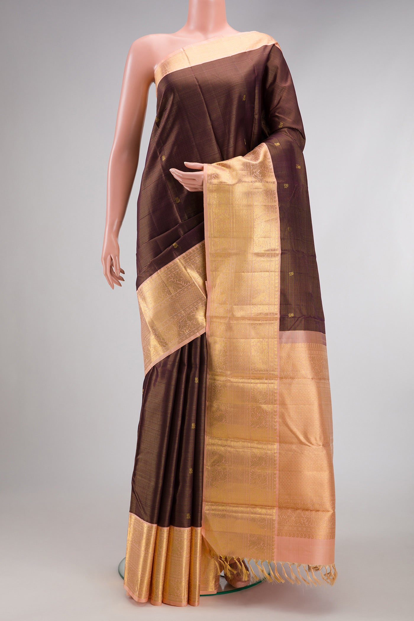 Coffee Brown Kanchipuram Silk Saree with Zari Butta on the body and Zari Border.  displayed on a mannequin
