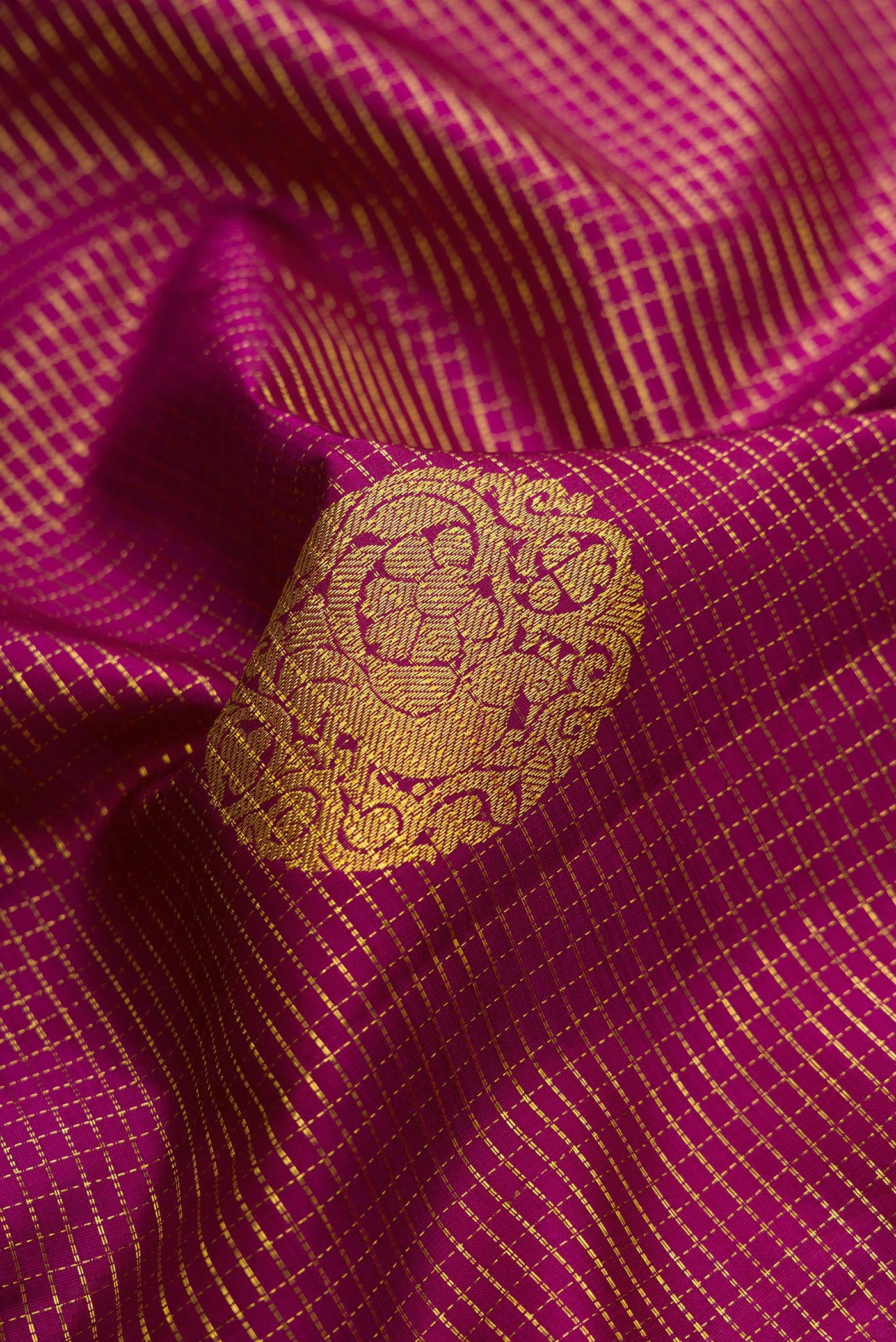 Close up of Purple Dual Tone Kanjivaram Silk Saree with Checked design on the body and Zari Border.  displaying folds