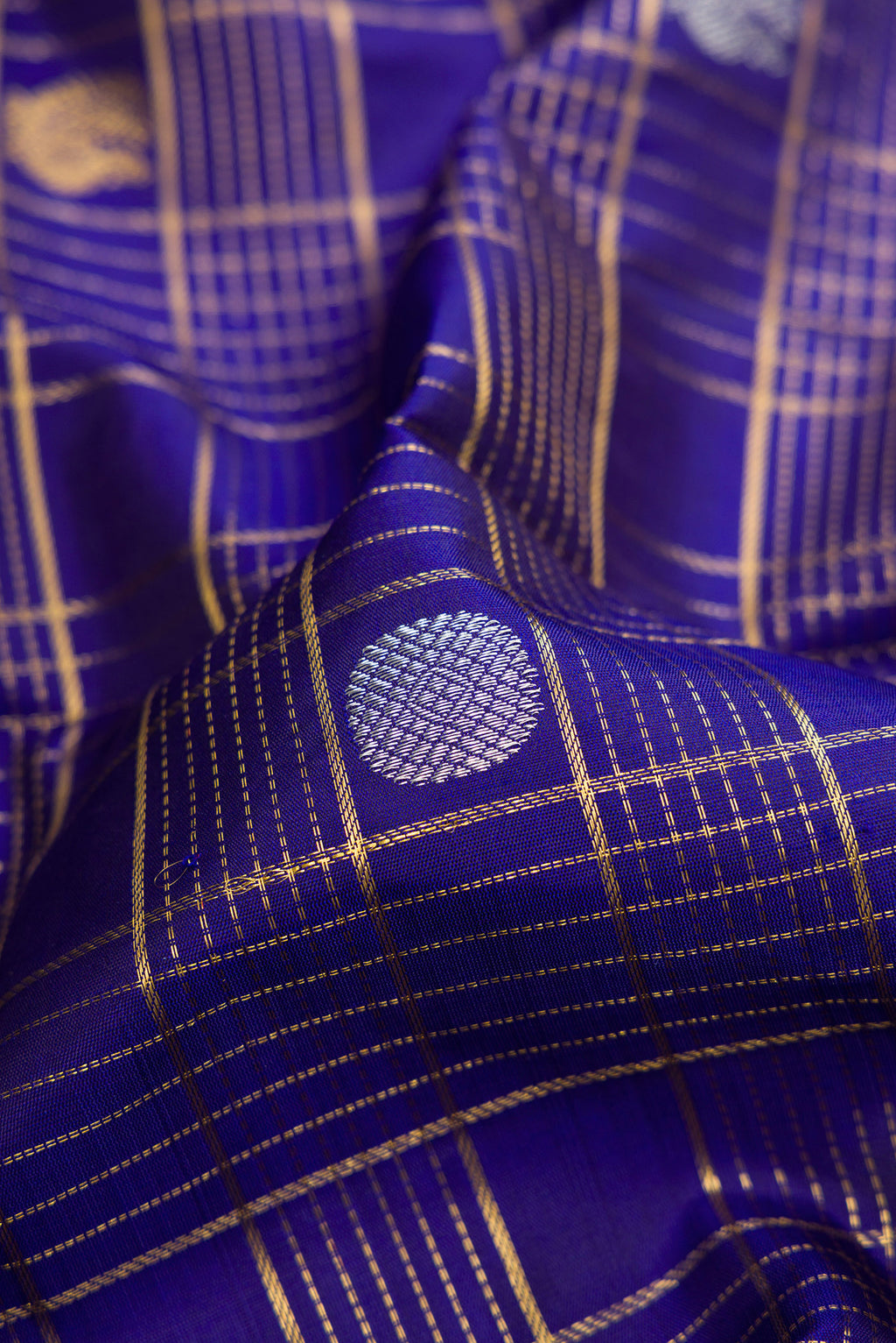 Close up of Pure Silk Pure Zari Royal Blue Dual Tone Kanchipuram Saree with Checked design on the body and Zari Border.  displaying folds