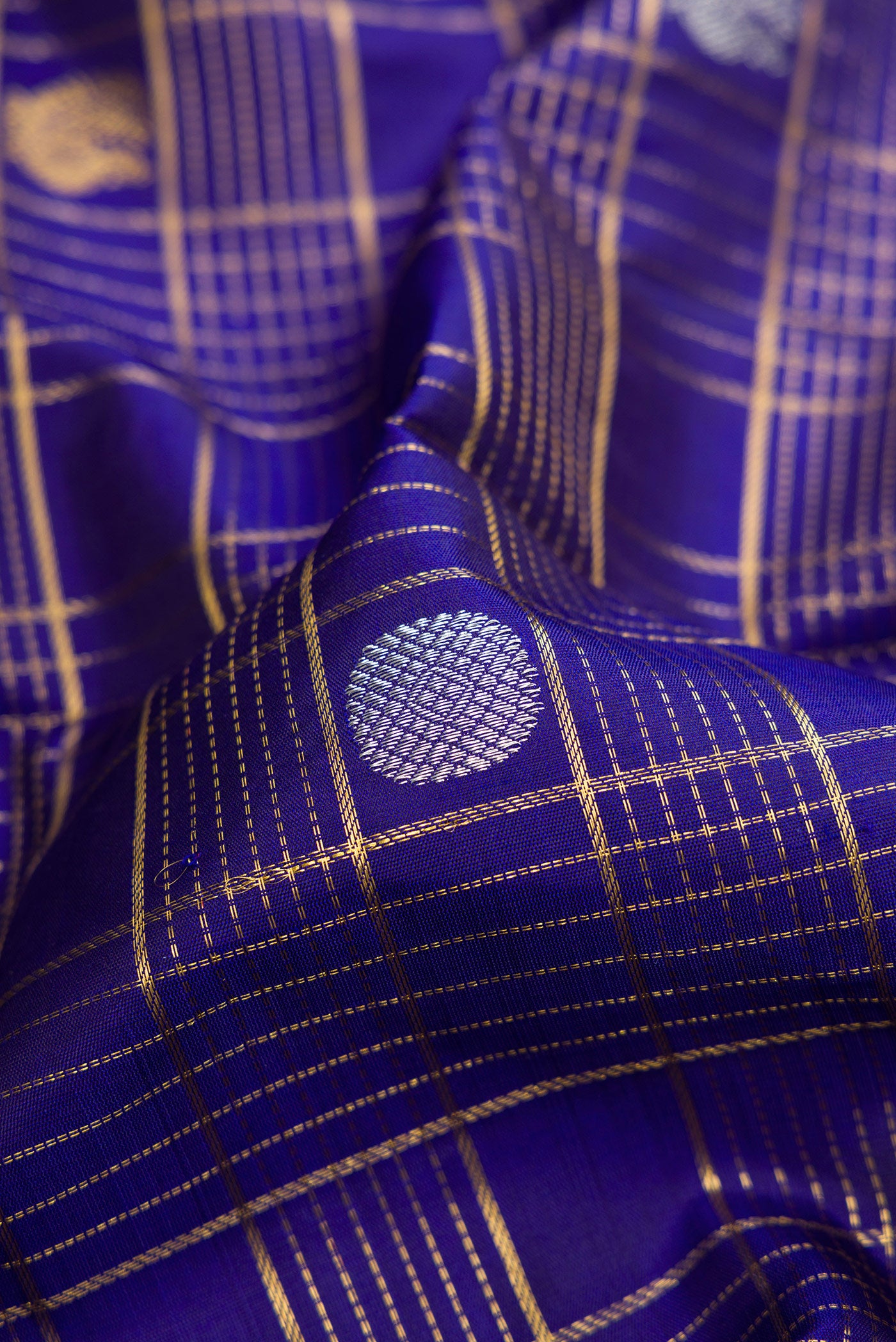 Close up of Pure Silk Pure Zari Royal Blue Dual Tone Kanchipuram Saree with Checked design on the body and Zari Border.  displaying folds