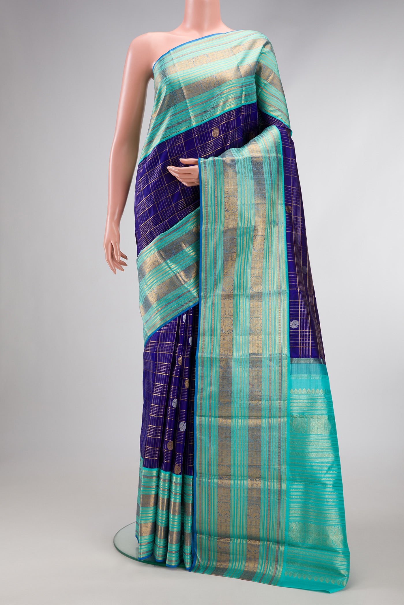 Pure Silk Pure Zari Royal Blue Dual Tone Kanchipuram Saree with Checked design on the body and Zari Border.  displayed on a mannequin