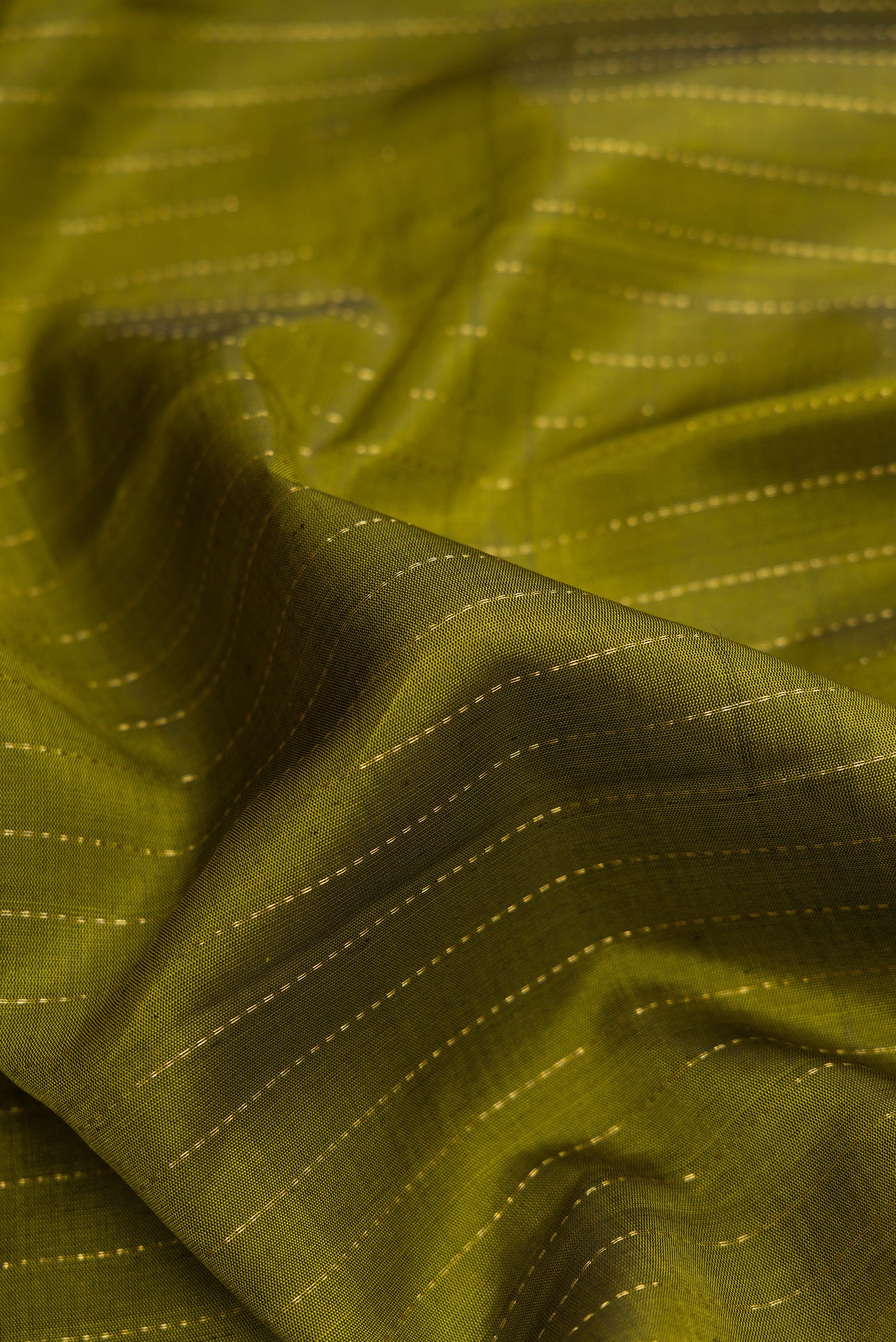 Close up of Mehandi Green Dual Tone Kanjivaram Silk Saree with Stripes on the body and Checks Border.  displaying folds