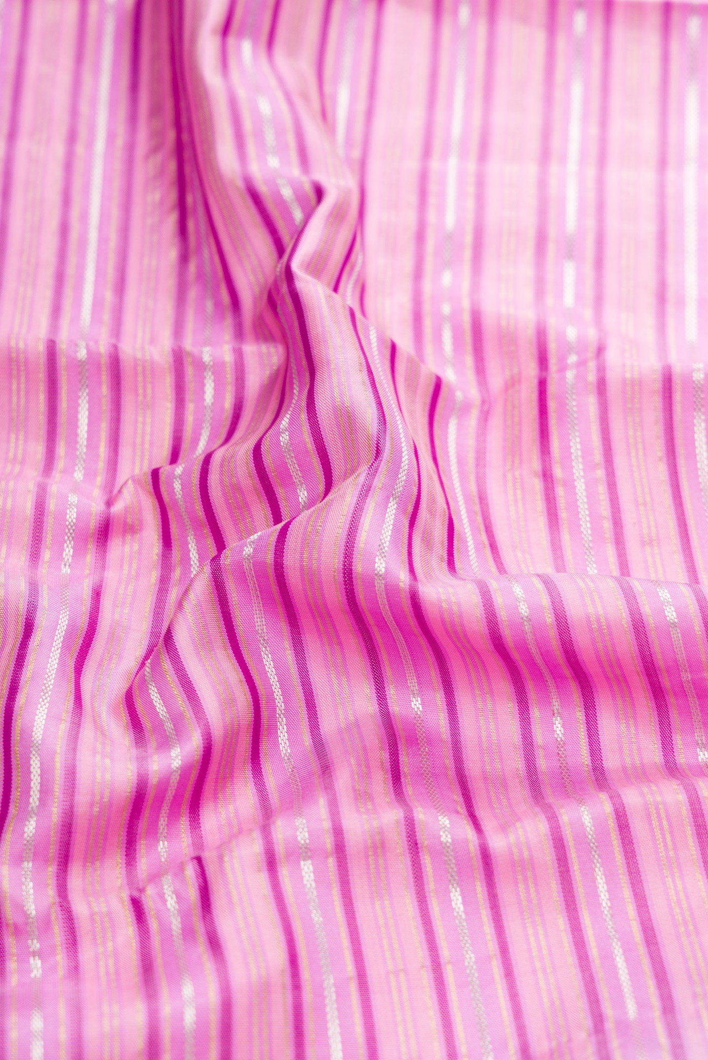 Close up of Lavender Kanchipuram Silk Saree with Stripes on the body and Zari Border.  displaying folds