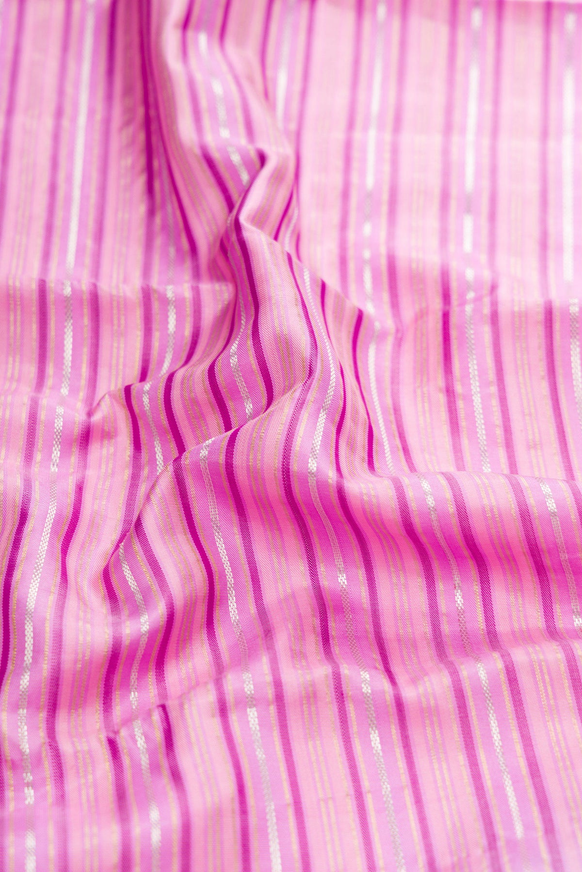 Close up of Lavender Kanchipuram Silk Saree with Stripes on the body and Zari Border.  displaying folds