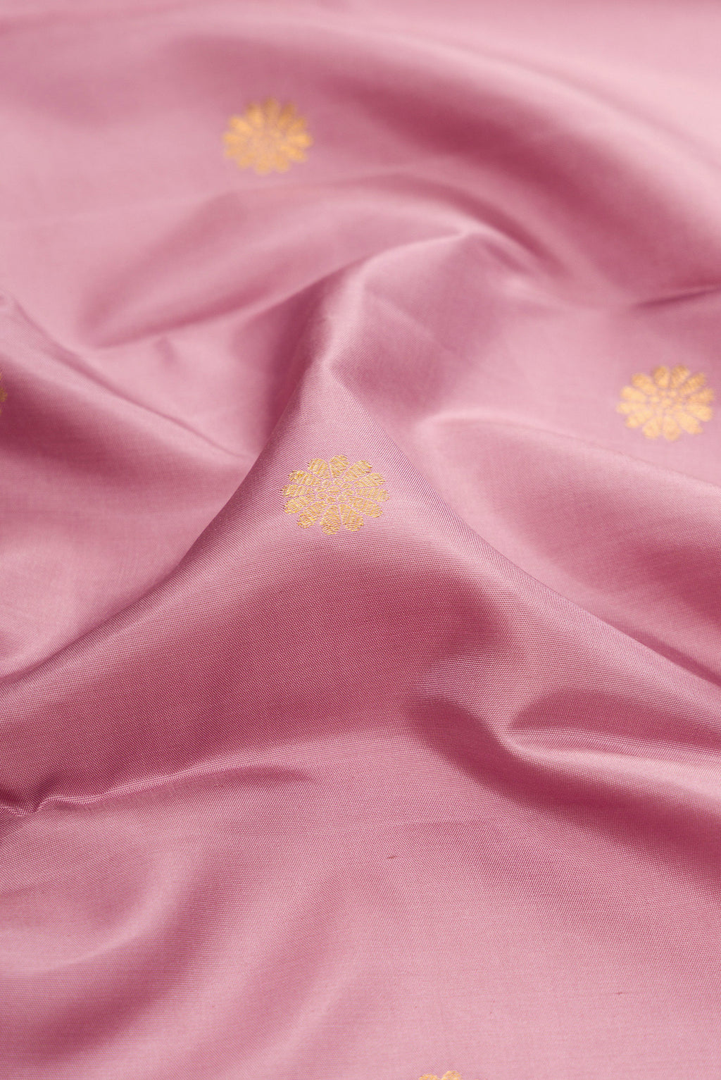 Close up of Lavender Kanjivaram Silk Saree with Zari Butta on the body and Ganga Jamuna Border.  displaying folds