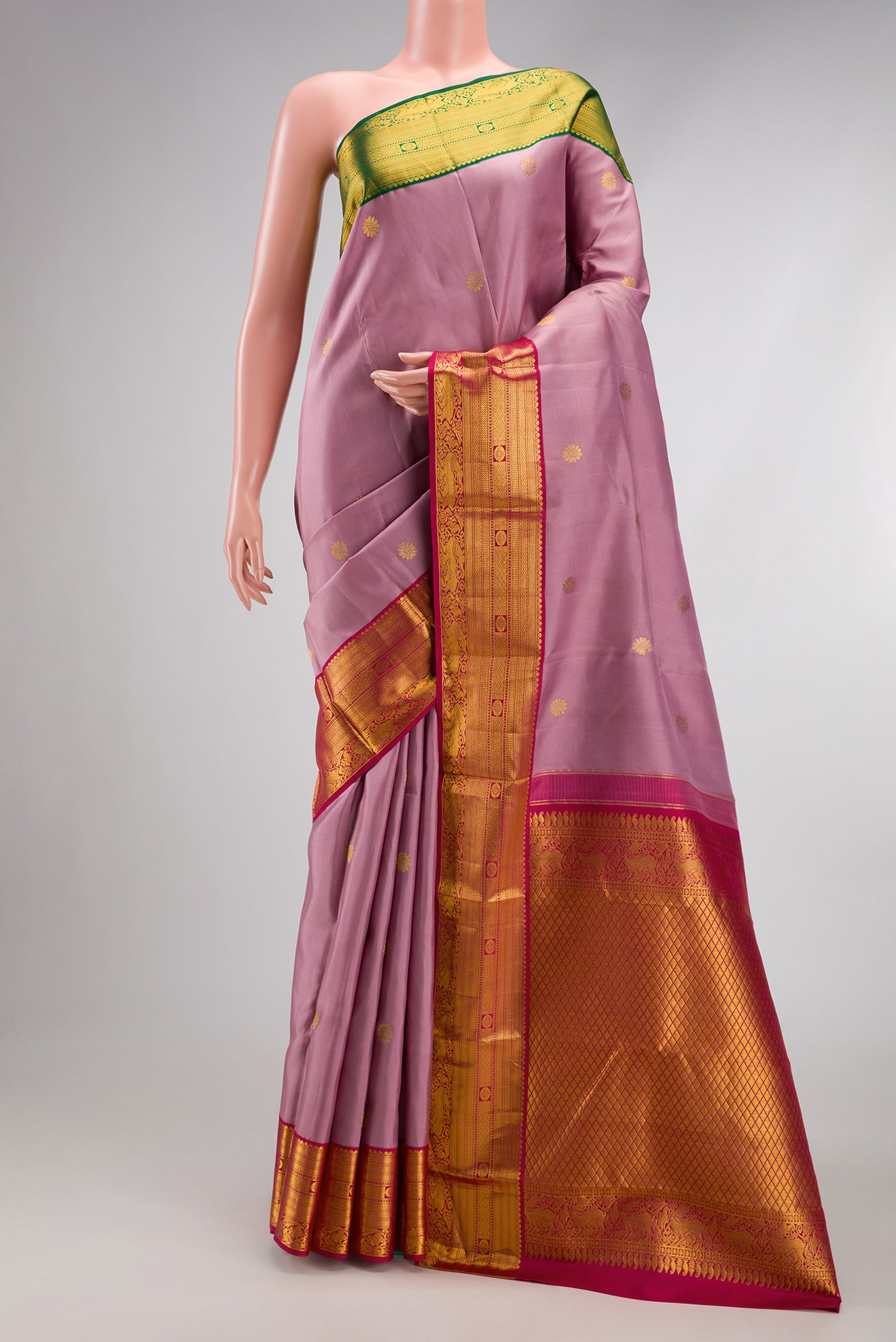 Lavender Kanjivaram Silk Saree with Zari Butta on the body and Ganga Jamuna Border.  displayed on a mannequin