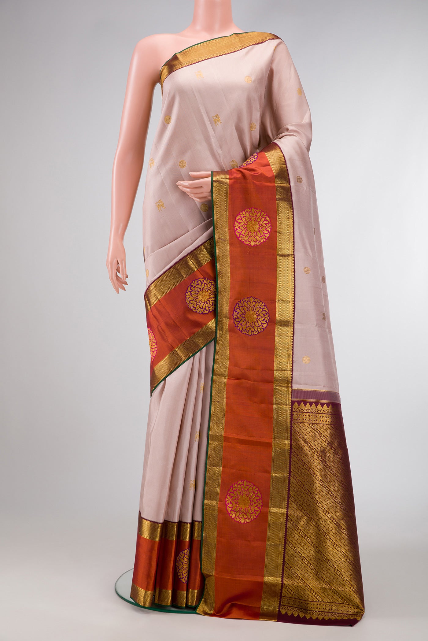 Rose Gold Dual Tone Kanjivaram Silk Saree with Zari Butta on the body and Fancy Border.  displayed on a mannequin