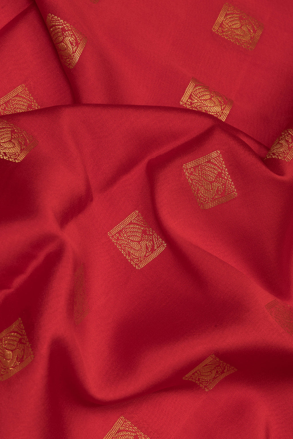 Close up of Red Mysore Crepe Saree with Zari Butta on the body and Zari Border.  displaying folds