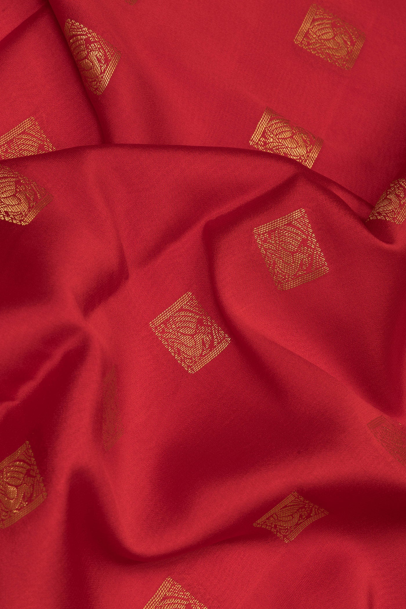 Close up of Red Mysore Crepe Saree with Zari Butta on the body and Zari Border.  displaying folds
