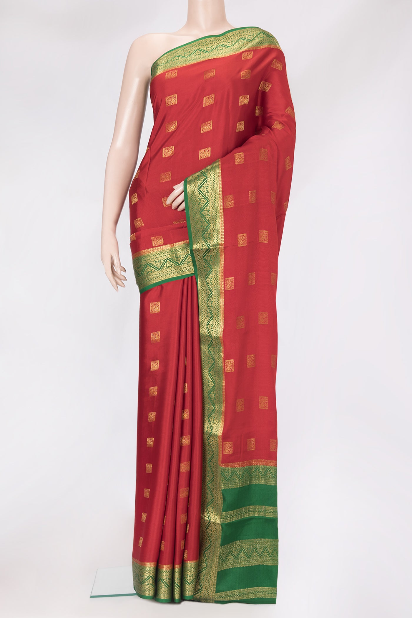 Red Mysore Crepe Saree with Zari Butta on the body and Zari Border.  displayed on a mannequin