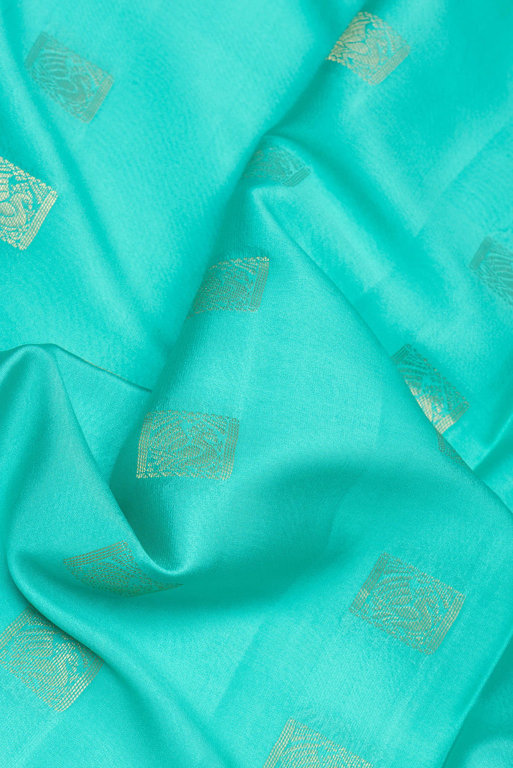 Close up of Turquoise Mysore Silk Saree with Zari Butta on the body and Zari Border.  displaying folds