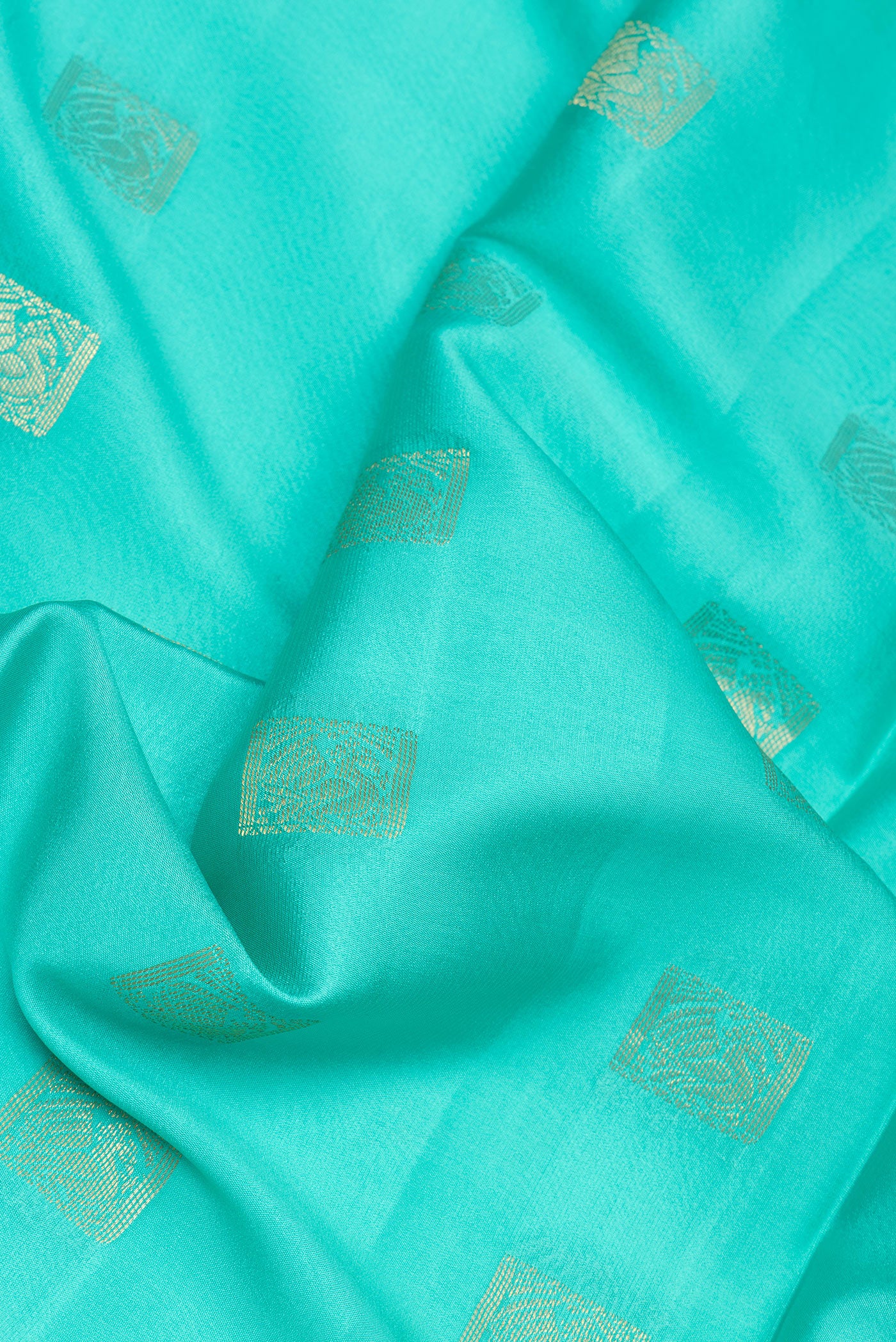 Close up of Turquoise Mysore Silk Saree with Zari Butta on the body and Zari Border.  displaying folds